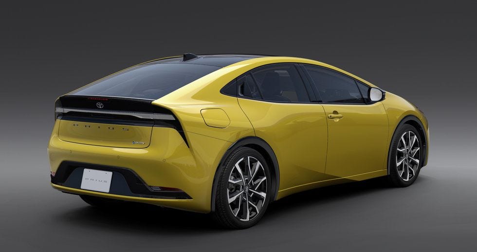 Press photo of a yellow 2023 Toyota Prius, seem from behind and to the right